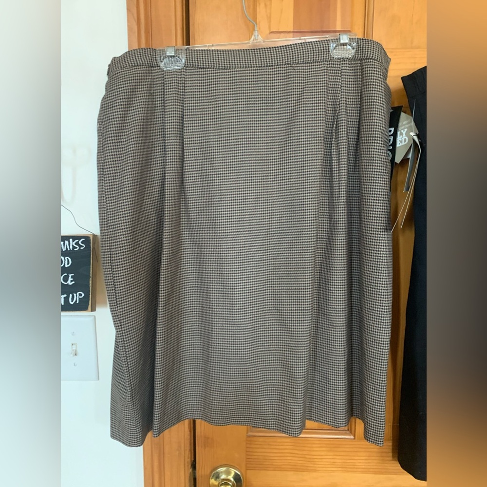 Two women’s knee length skirts 22W. One black and one plaid.